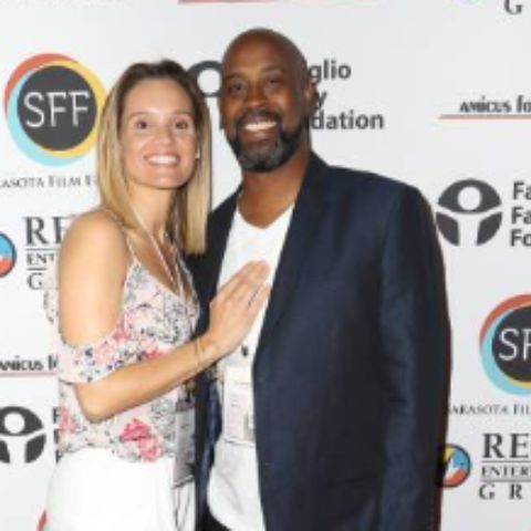 Kenny Anderson posing with his third wife, Natasha Anderson during an event
